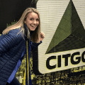 Woman smiling in front of Citgo sign artwork