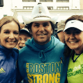 Group of three people smiling at camera during Boston Marathon