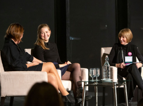 Speakers Chessy and Susan Prout on stage with moderator Karin Miller at the 2019 Women at the Center Kickoff