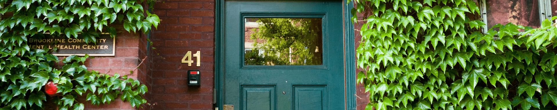 Website header image featuring the front door of The Brookline Center